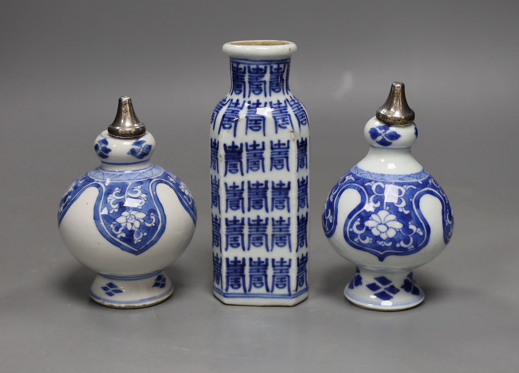 A pair of Chinese Kangxi blue and white rose water sprinklers (cut down) and an unusual 19th century Chinese blue and white ‘Hundred Shou’ jar, rose sprinklers: 10cms high excluding metal tops